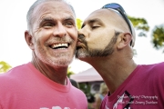 One man kissing another man on the cheek