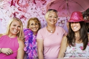Four ladies having fun with props in the photo booth