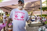 Man at Pink Out holding a pan