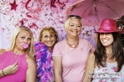 Four ladies having fun with props in the photo booth